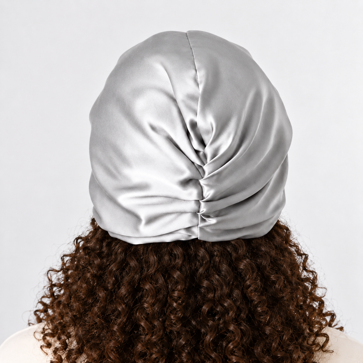 Back view of the silver organic silk sleep bonnet showing the gathered back